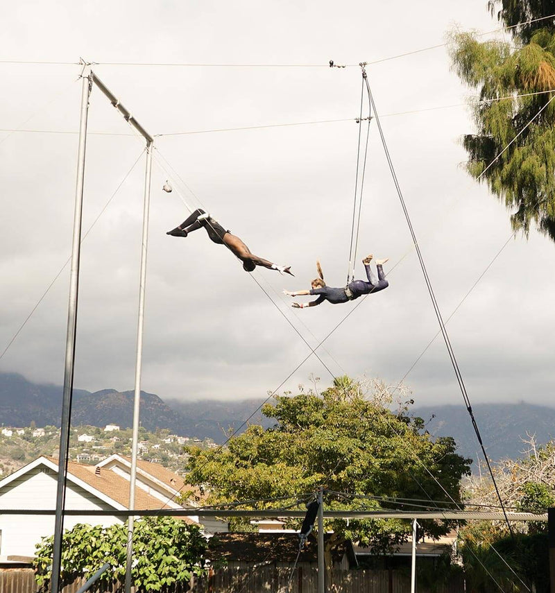 Flyer mid-swing on the flying trapeze in Santa Barbara